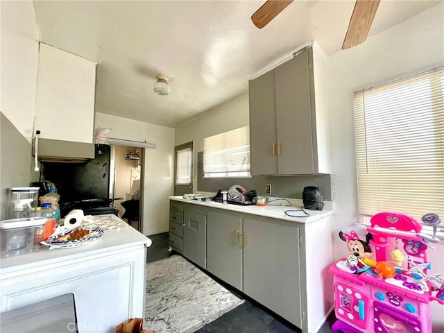 kitchen featuring gray cabinets and ceiling fan