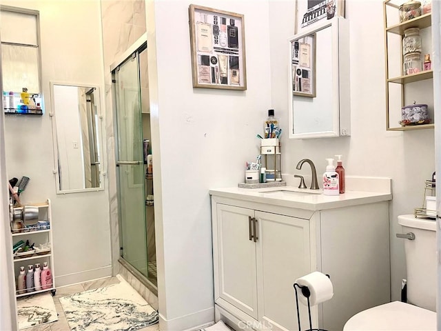 bathroom featuring vanity, toilet, and a shower with door