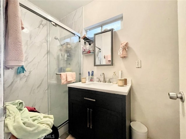 bathroom featuring vanity and a shower with shower door