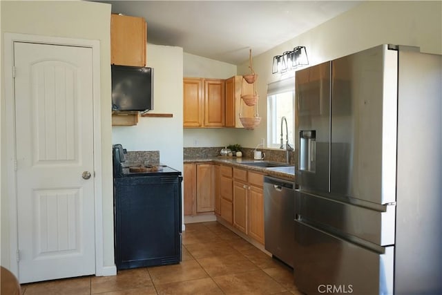 kitchen featuring appliances with stainless steel finishes, tile patterned floors, and sink