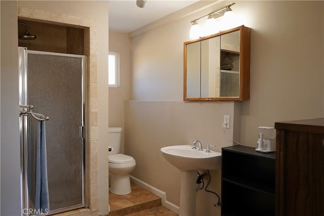 bathroom featuring toilet, tile patterned floors, walk in shower, and sink