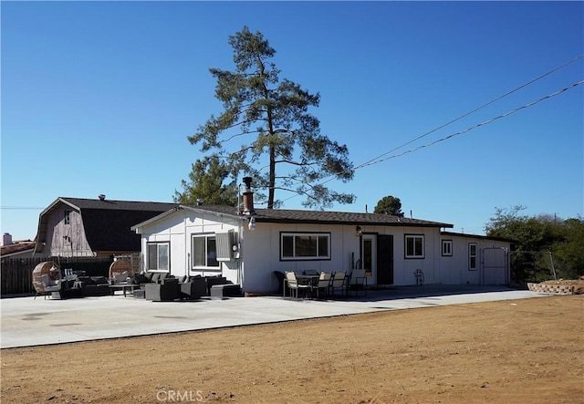 rear view of property with an outdoor hangout area and a patio