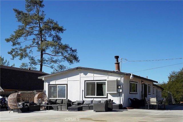 rear view of property featuring an outdoor hangout area and a patio