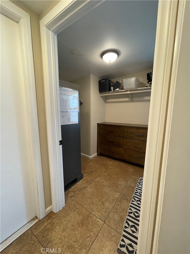 spacious closet featuring light tile patterned floors