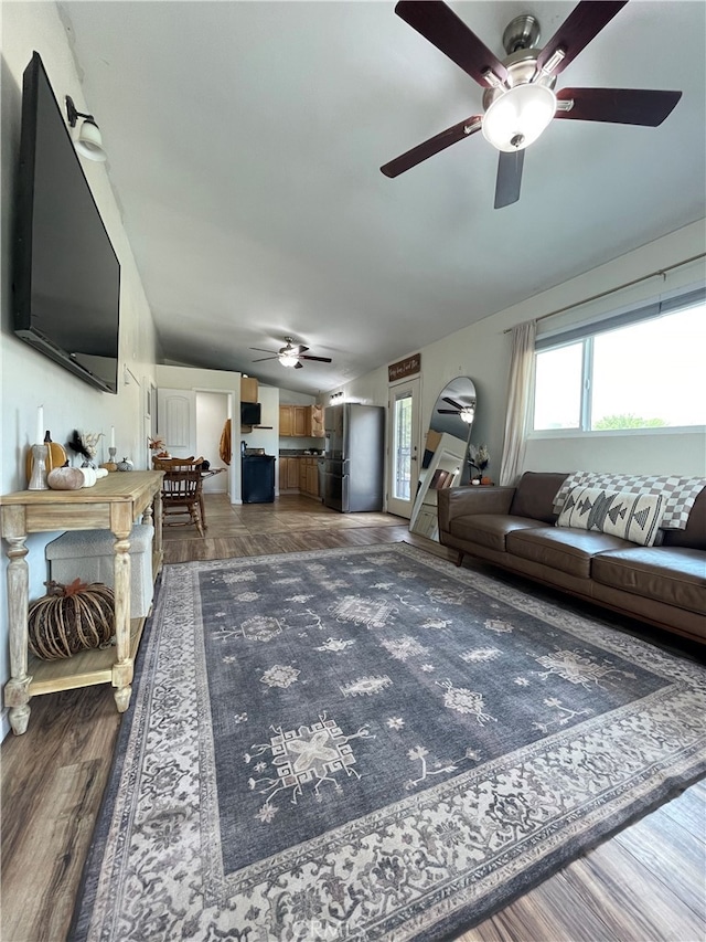 living room featuring dark hardwood / wood-style flooring and lofted ceiling