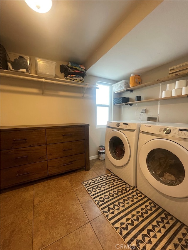 laundry area featuring washer and dryer and light tile patterned flooring