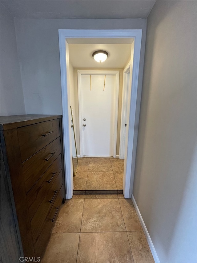 corridor featuring light tile patterned floors