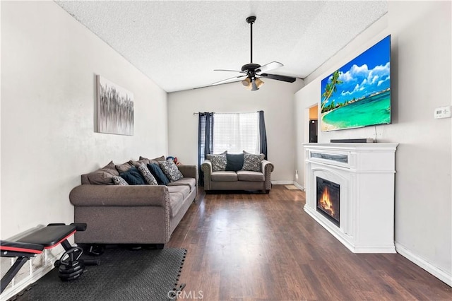 living room featuring a textured ceiling, dark hardwood / wood-style floors, vaulted ceiling, and ceiling fan