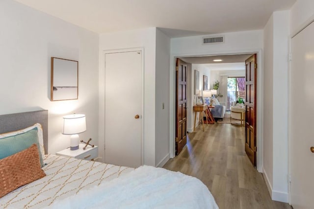 bedroom featuring light wood-type flooring and a closet