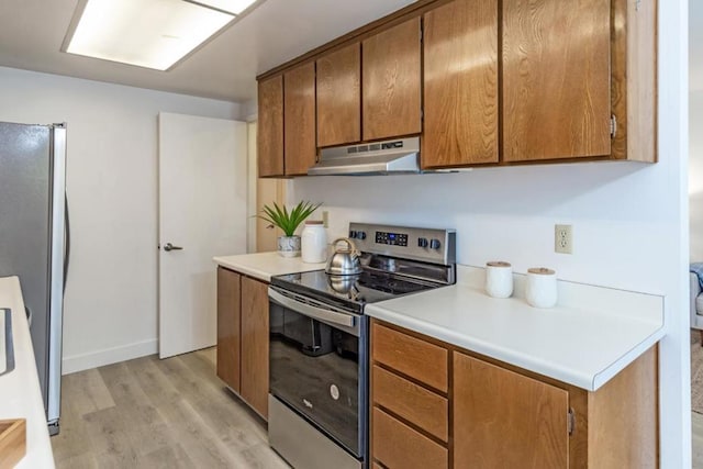 kitchen featuring stainless steel appliances and light hardwood / wood-style flooring