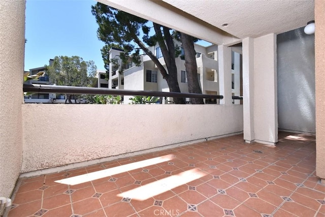 view of patio featuring a balcony