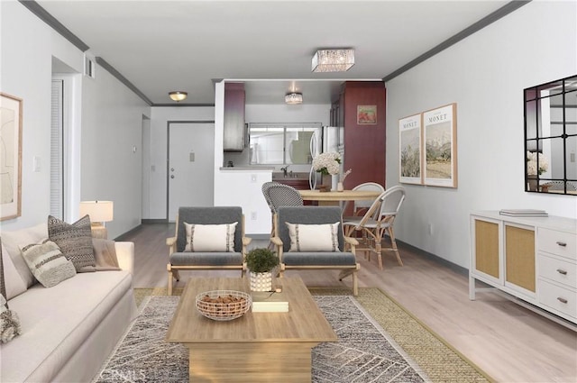 living room featuring hardwood / wood-style floors and crown molding