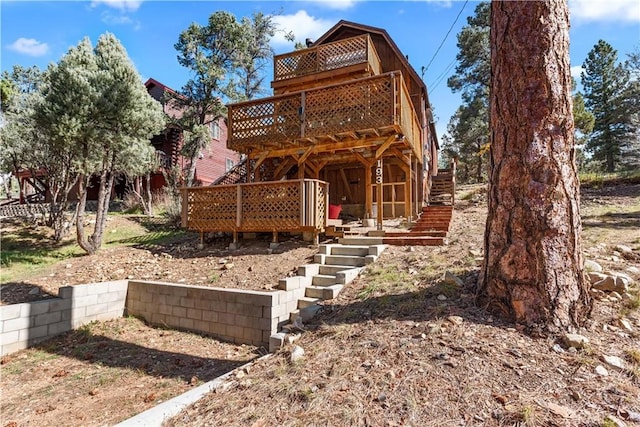 back of property with a wooden deck