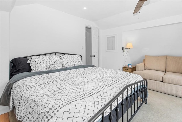 carpeted bedroom featuring ceiling fan and vaulted ceiling