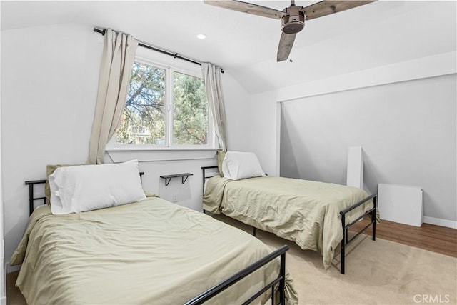 bedroom featuring light hardwood / wood-style floors, ceiling fan, and lofted ceiling