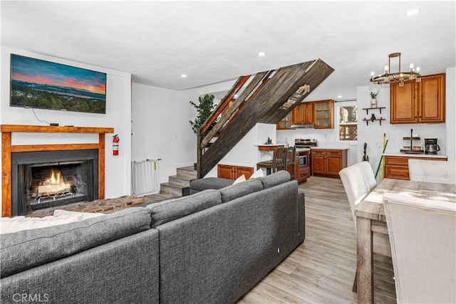 living room with a notable chandelier and light wood-type flooring