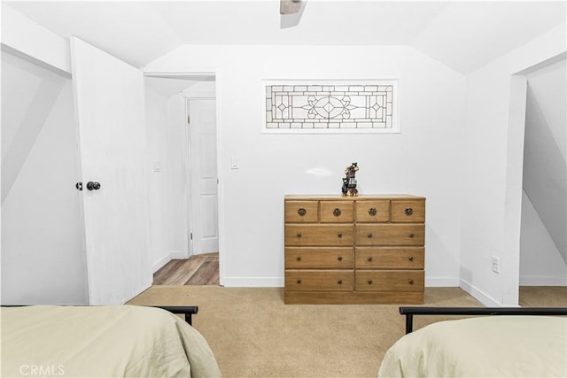 carpeted bedroom with lofted ceiling