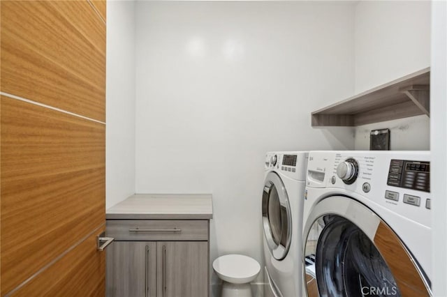 clothes washing area with washing machine and clothes dryer