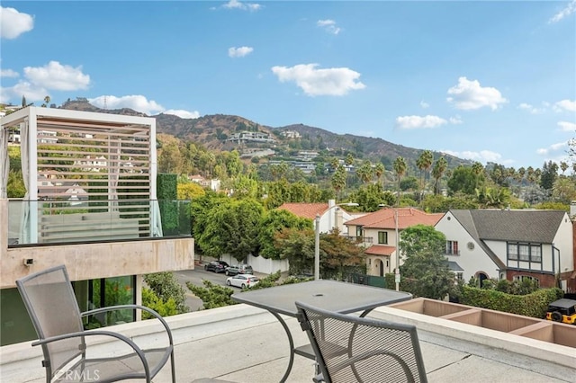 exterior space with a balcony and a mountain view