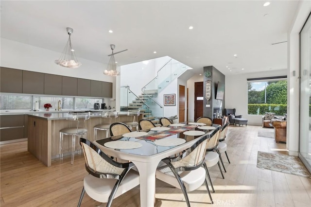 dining space with sink and light hardwood / wood-style floors