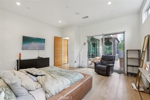 bedroom featuring light hardwood / wood-style floors and access to outside