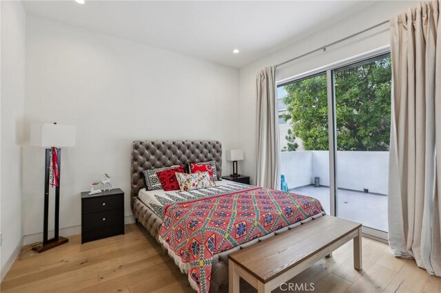 bedroom with light hardwood / wood-style floors and access to outside