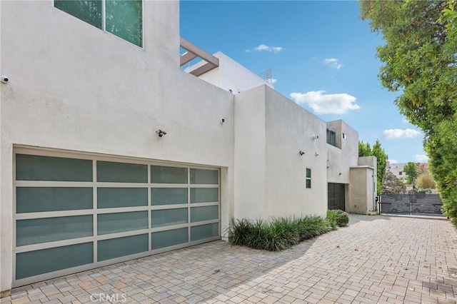 view of side of home featuring a garage