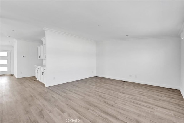 unfurnished living room featuring light wood-type flooring and crown molding