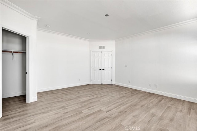 unfurnished bedroom with light wood-type flooring and ornamental molding