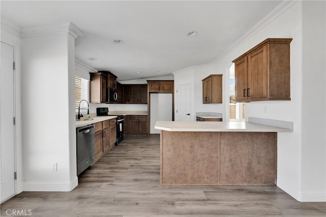 kitchen with appliances with stainless steel finishes, light hardwood / wood-style flooring, and plenty of natural light