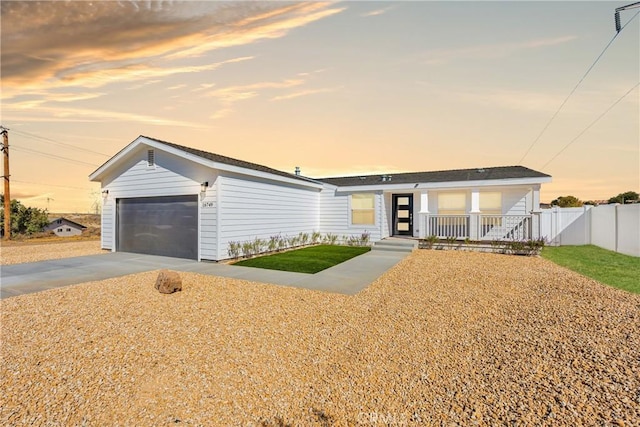 single story home featuring covered porch and a garage