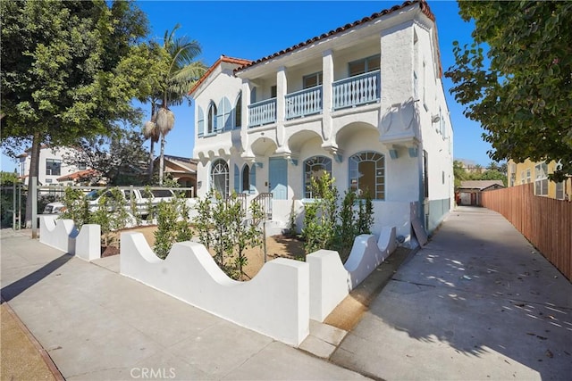 mediterranean / spanish house featuring a balcony