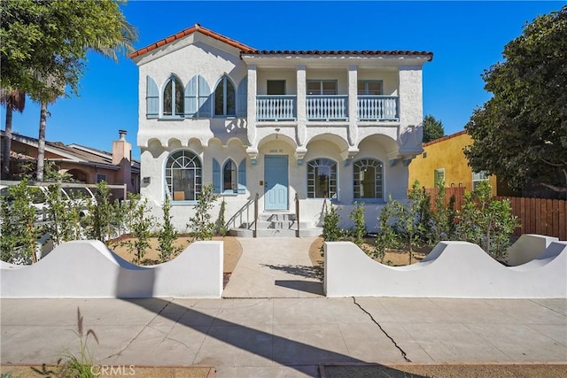 mediterranean / spanish-style home featuring a balcony