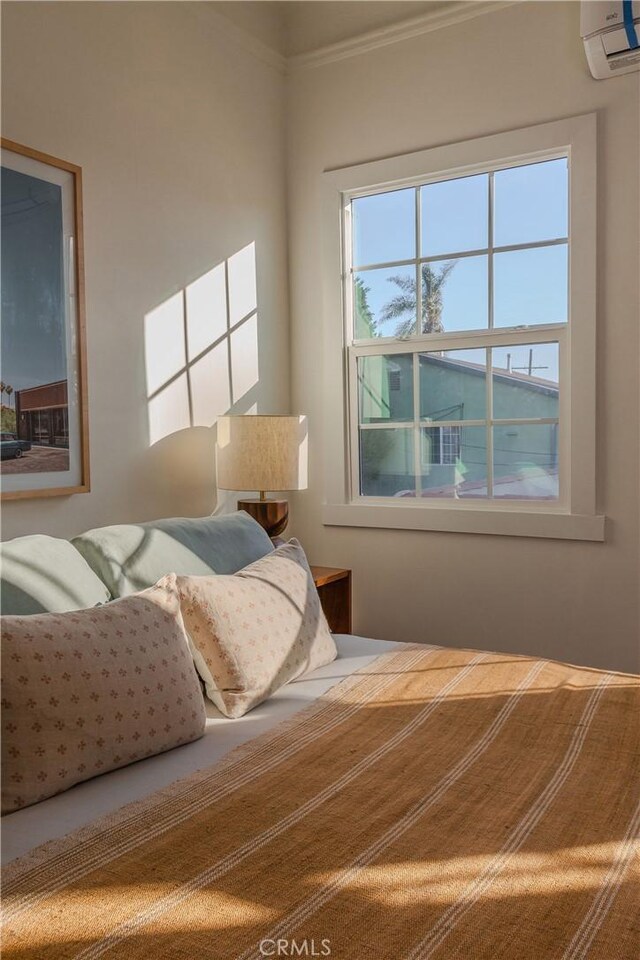 bedroom featuring a wall mounted AC