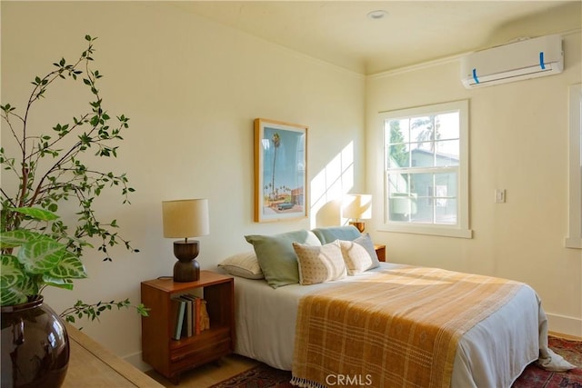 bedroom with an AC wall unit