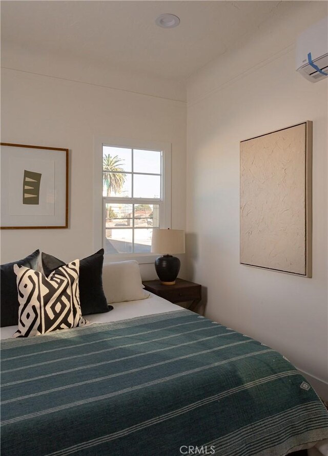 bedroom featuring a wall mounted air conditioner