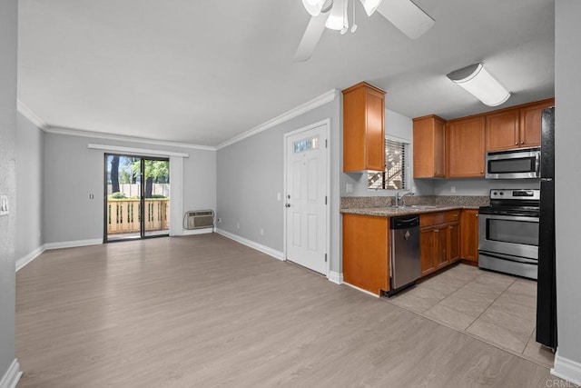 kitchen featuring light wood-type flooring, stainless steel appliances, ceiling fan, and ornamental molding