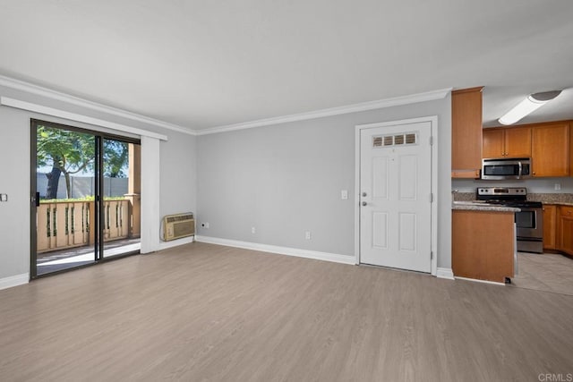 unfurnished living room with a wall mounted AC, crown molding, and light hardwood / wood-style flooring