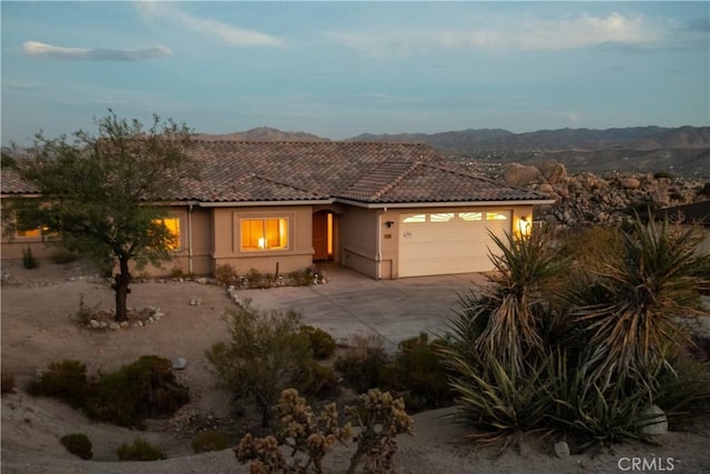 view of front facade with a mountain view and a garage