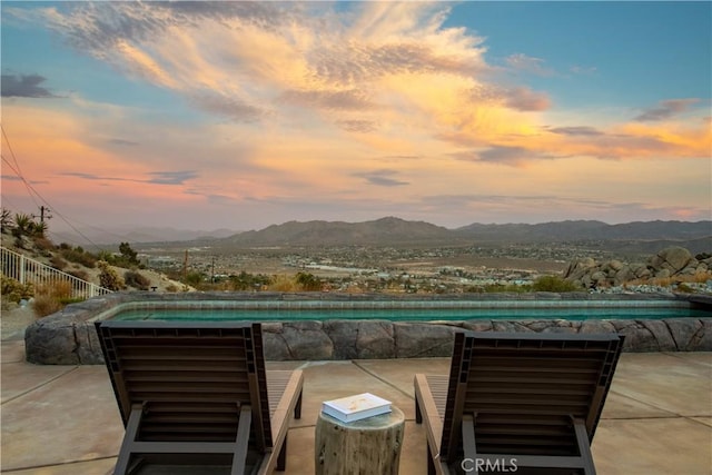 patio terrace at dusk with a mountain view