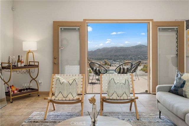 sitting room with a mountain view and tile patterned floors