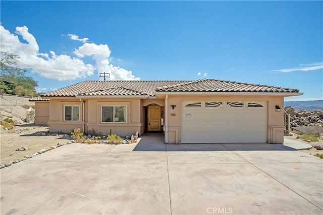 mediterranean / spanish-style home featuring a garage