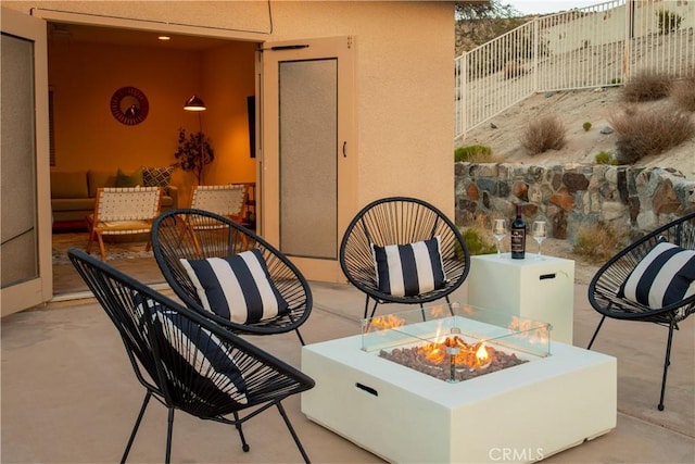 balcony with a fire pit and a patio