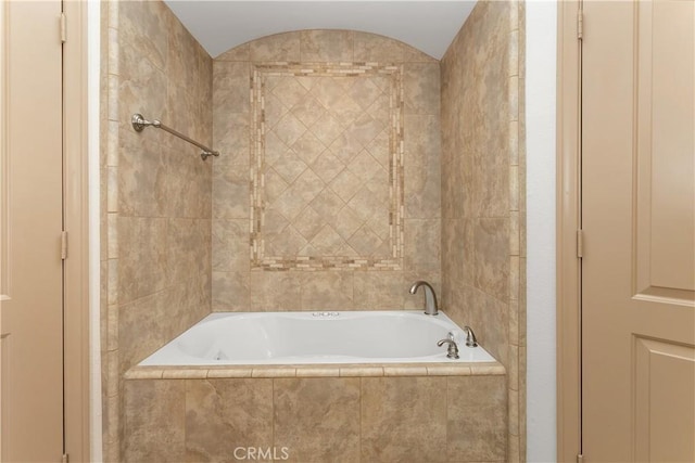 bathroom with tiled bath