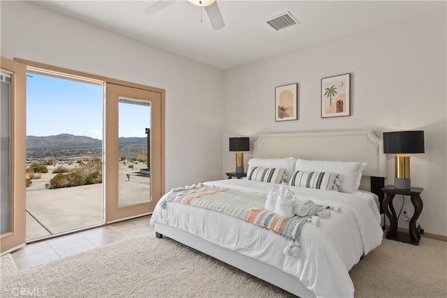 tiled bedroom featuring access to outside, a mountain view, and ceiling fan