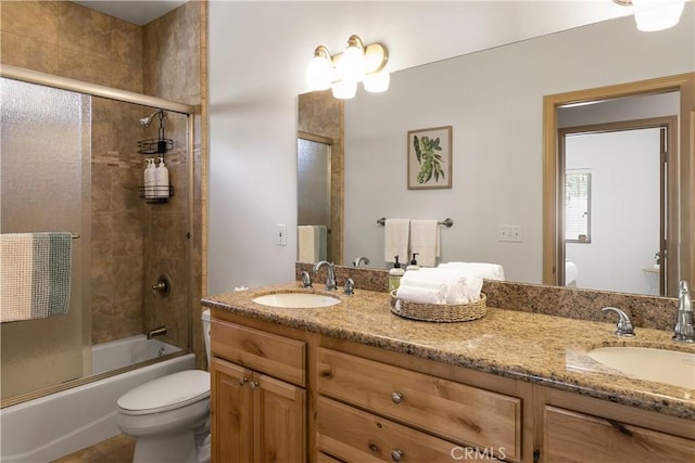 full bathroom with shower / bath combination with glass door, vanity, toilet, and tile patterned flooring