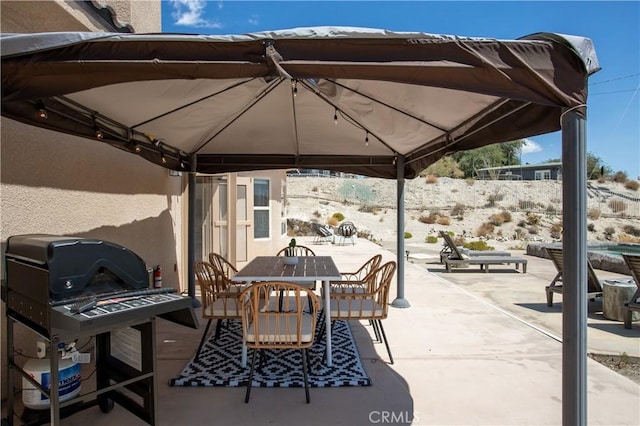 view of patio / terrace featuring a gazebo and a grill