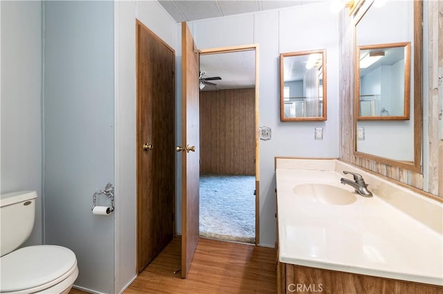 bathroom with vanity, hardwood / wood-style flooring, toilet, and ceiling fan