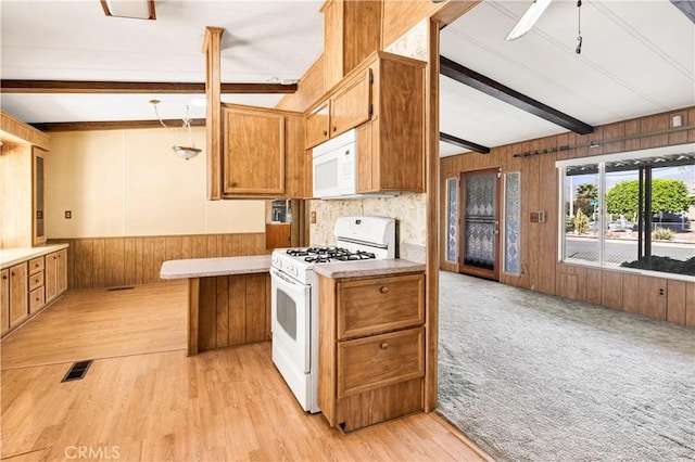 kitchen with beam ceiling, ceiling fan, white appliances, and light wood-type flooring