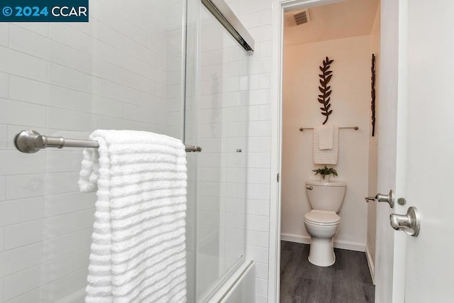 bathroom with hardwood / wood-style flooring and toilet